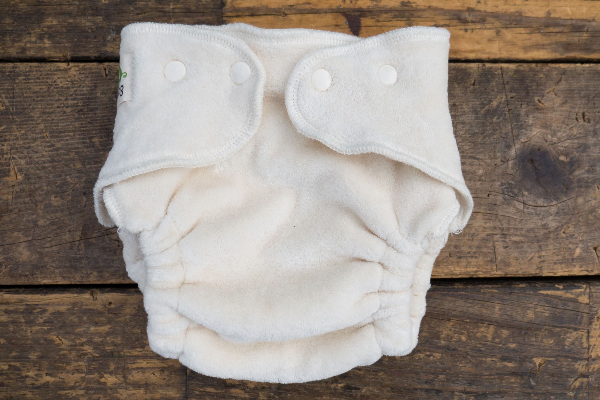 Closeup shot of organic white baby diapers on a wooden surface